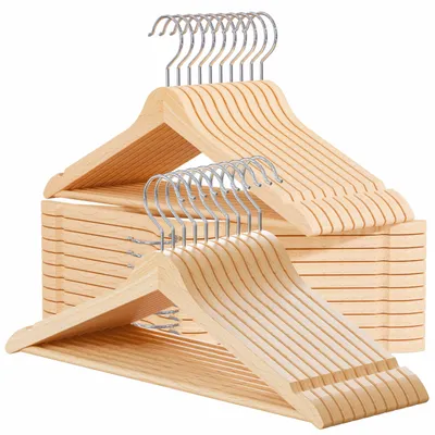 A stack of wooden hangers with metal hooks, arranged in a neat pile.