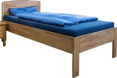 A wooden bed with blue bedding against a white background.