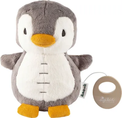 A plush toy penguin with a music box attached.