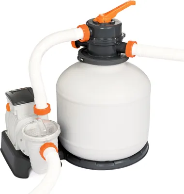 A white sand filter system for a swimming pool, connected to a pump.