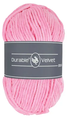 A ball of pink yarn with a gray label wrapped around its middle.