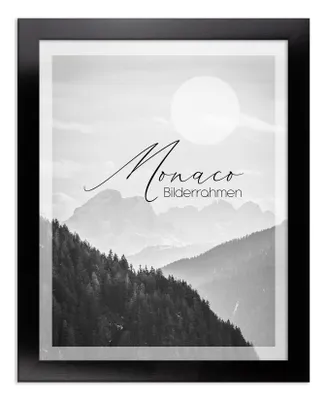 A framed picture of mountains with text overlay.