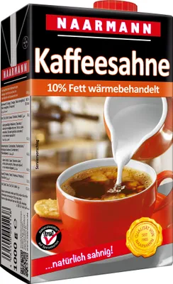 A carton of coffee cream being poured into a cup of coffee.