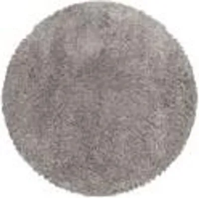 A round, beige, high-pile rug.