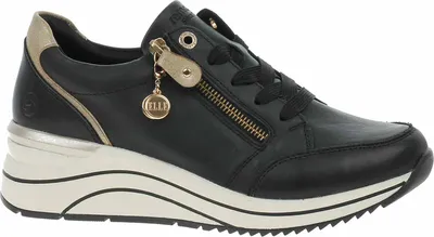 A studio shot of a black leather sneaker with gold accents and a white sole.