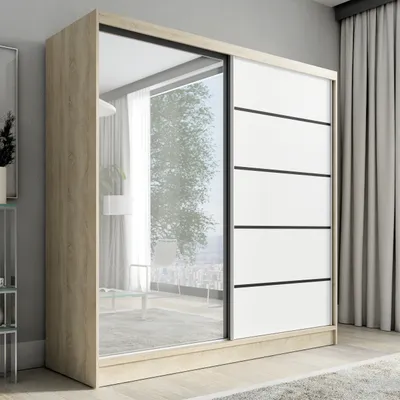 A modern sliding door wardrobe with a mirrored door and white panels with black accents, set in a bedroom.