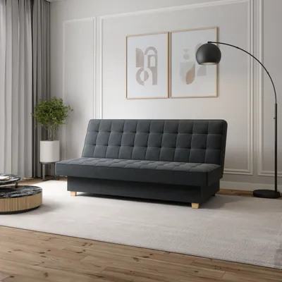 A modern living room with a sofa, floor lamp, and artwork.