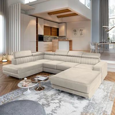 A spacious, modern living room with a large sectional sofa, kitchen area, and dining area visible in the background.