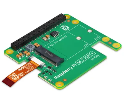 A close-up, angled view of a green circuit board with black connectors and orange ribbon cable.