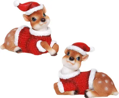 Two small decorative reindeer figurines wearing Santa hats and red sweaters, lying down.
