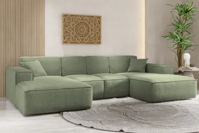 A U-shaped sectional sofa in a light green corduroy fabric, placed on a rug in a well-lit room with minimalist decor.