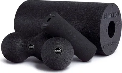 A collection of black foam rollers and balls for fascia massage.