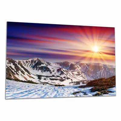 Produktbild von Wallario Herdabdeckplatte aus Glas, Größe 80 x 52 cm 1-teilig, Motiv Farbenfroher Sonnenuntergang im Winter - Schnee in den Bergen
