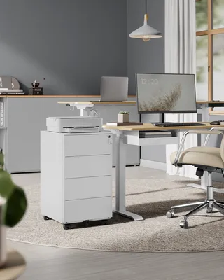 An office desk setup with a computer, printer, and filing cabinet.
