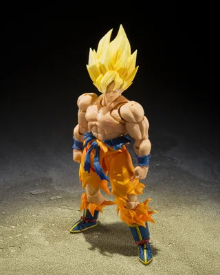 A Dragon Ball Z Super Saiyan Son Goku action figure standing on a textured surface with a dark background.