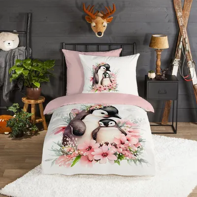A child's bedroom with a bed dressed in penguin-themed bedding.