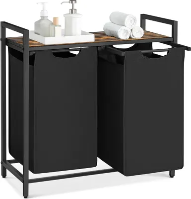 A laundry hamper with two compartments and a shelf on top, with some toiletries and towels on the shelf.