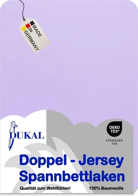A flat lay of a purple bedsheet with product information and certifications.