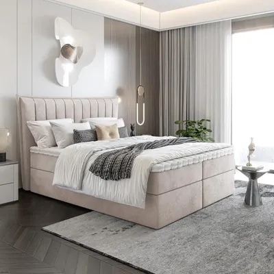 A modern bedroom with a beige upholstered bed.