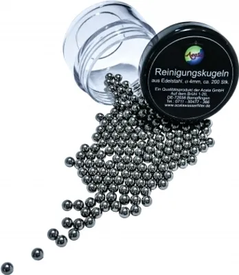 A pile of small metal balls spilling out of a clear plastic container, with a black lid.