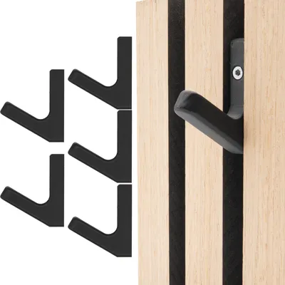 A set of black hooks on a wooden acoustic panel.