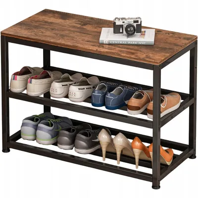 A shoe rack with a wooden top, holding several pairs of shoes on three shelves. A camera and a book are on the top surface.
