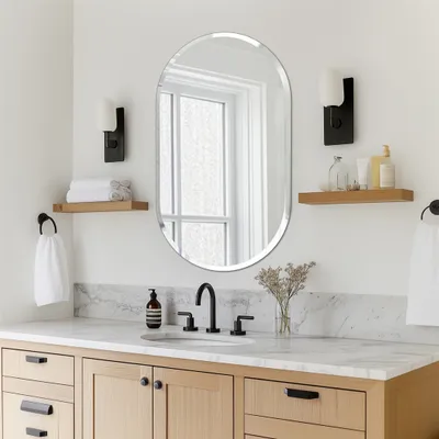 A modern bathroom vanity with a mirror, sink, and accessories.