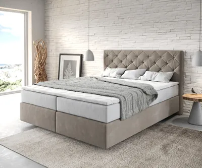 A bedroom scene with a boxspring bed.