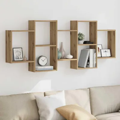 A wooden wall shelf unit mounted on a white wall above a sofa.