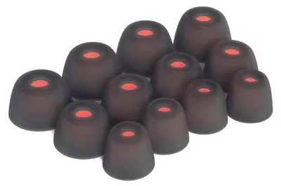 A collection of black silicone ear tips with red centers, arranged in a cluster on a white background.