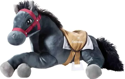 A plush toy horse lying down, with a saddle on its back.