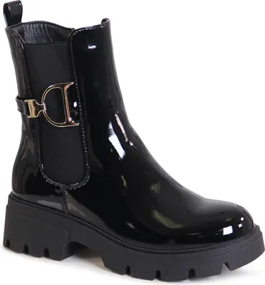 A single black patent leather boot with a chunky sole and a gold buckle detail.