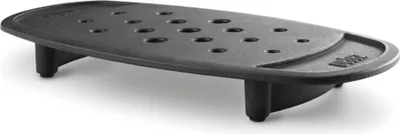 A black cast iron grill grate with multiple holes and legs, shown on a white background.