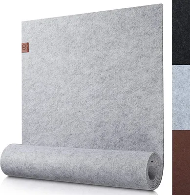 A light gray felt table runner is shown, partially rolled up at the bottom. A small brown logo tag is attached to the top left corner of the runner. To the right, there are swatches of other available colors: black, light gray, and brown.