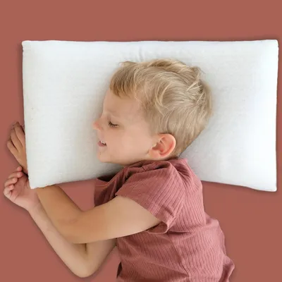 A young child sleeping on a pillow.