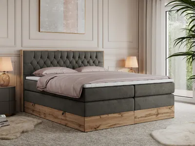 A bedroom scene with a king-size boxspring bed as the focal point.