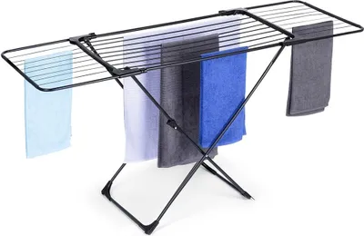 A black metal drying rack with several towels of different colors hanging on it, set against a white background.