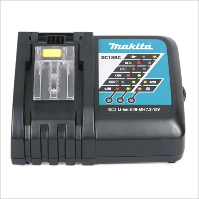 A black Makita DC18RC battery charger is shown against a white background. The charger has a clear plastic battery slot and a panel with indicator lights and the Makita logo.