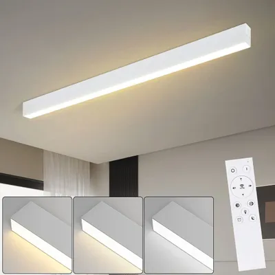 A long, white LED ceiling light fixture is shown mounted on a white ceiling. Below the main image, three smaller inset images show the light fixture at different color temperatures. A white remote control is also visible in the lower right corner.