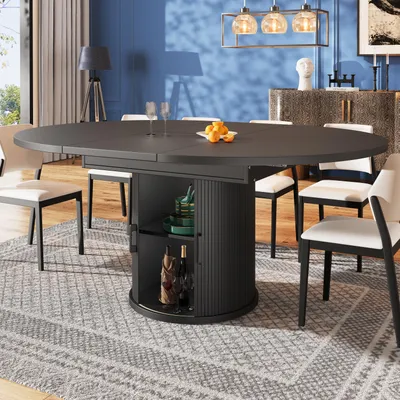 A dining room scene with a round extendable table and chairs.
