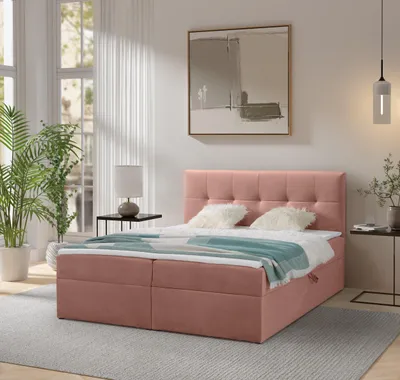 A bedroom scene with a pink box spring bed as the main focus.