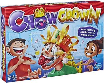 The image shows the box for the board game "Chow Crown" by Hasbro. It features cartoon characters playing the game, with a spinning crown and snacks.