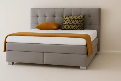 A bed with a headboard, mattress, and bedding in a room.
