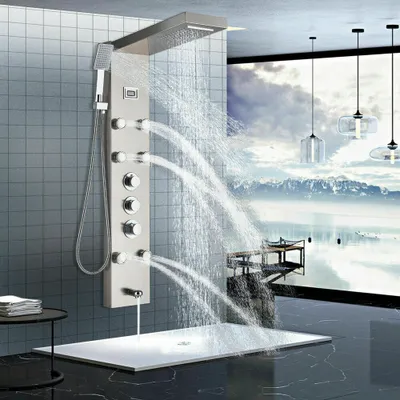 A modern bathroom with a sleek shower panel and a scenic view through a large window.