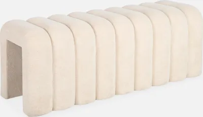 A beige upholstered bench with a curved, segmented design, shown against a white background.