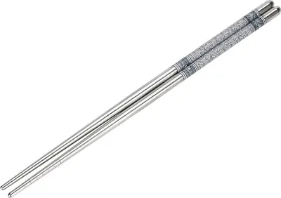 A pair of stainless steel chopsticks with decorative gray patterns.
