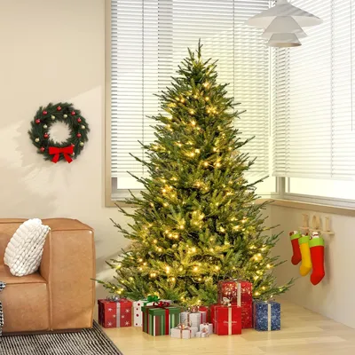 A decorated Christmas tree with presents underneath, a wreath on the wall, and stockings hanging by the fireplace.