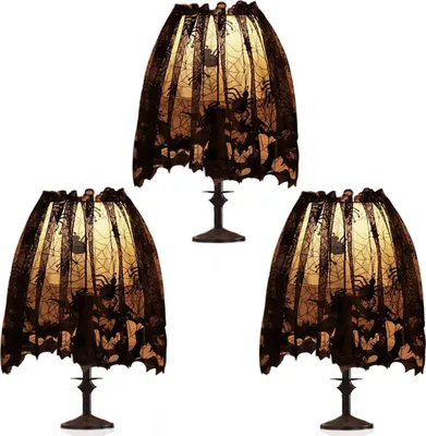 Three Halloween-themed lampshades with spiderweb and spider designs, displayed against a white background.