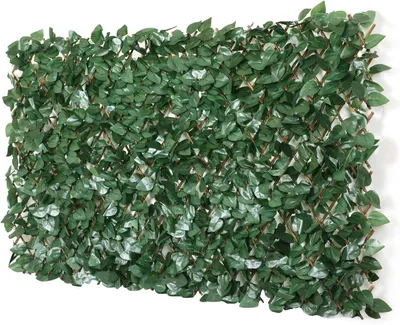 A close-up view of an expandable lattice fence covered in artificial green leaves.