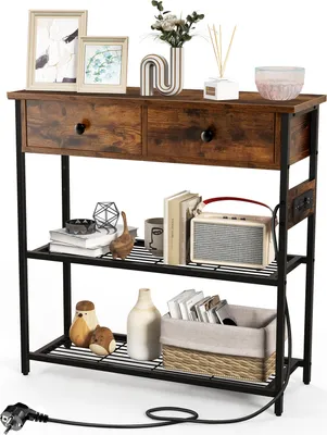 A console table with two drawers and two shelves, decorated with various items.